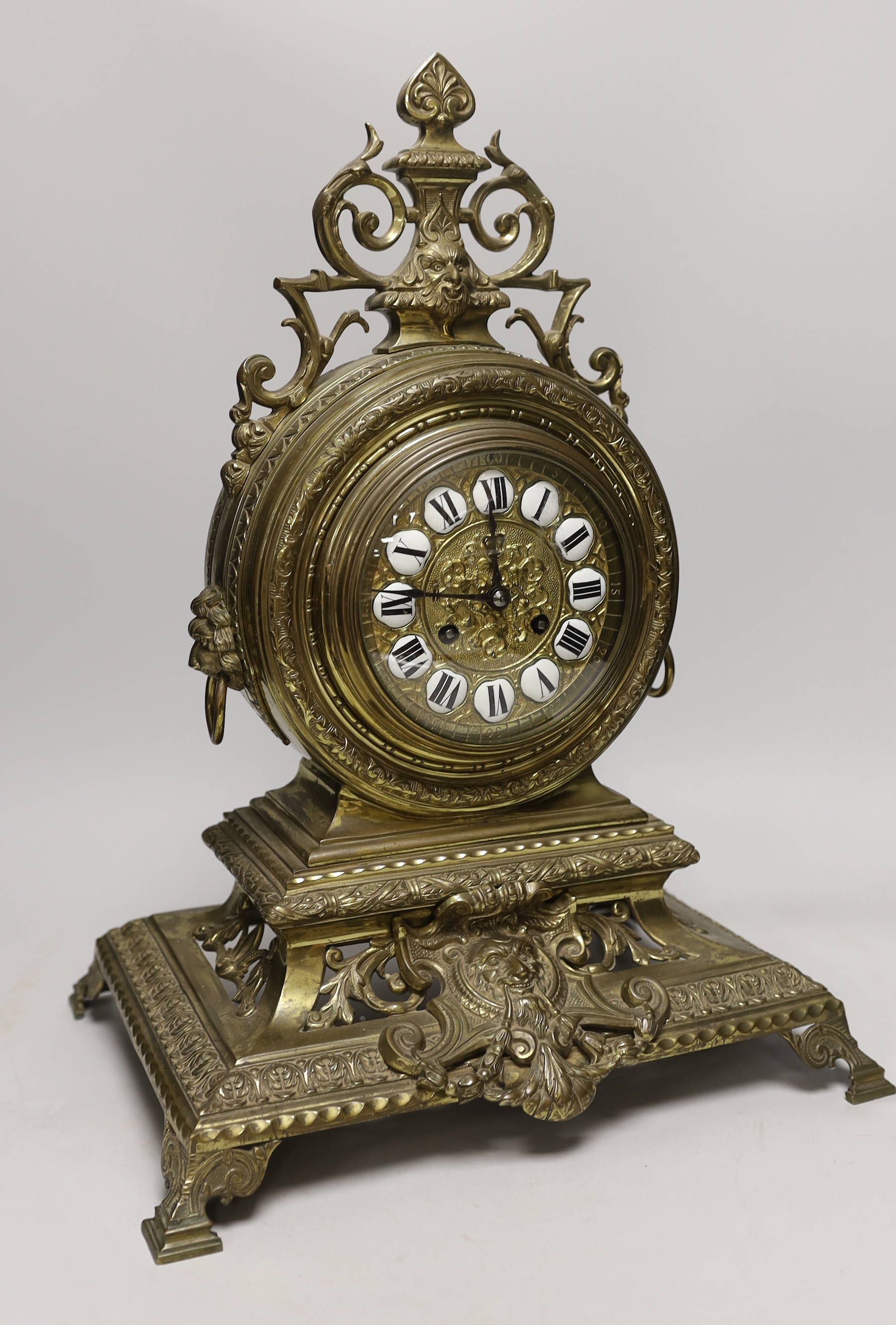 A late 19th century French Louis XIV revival brass drum shape clock, 46cm tall